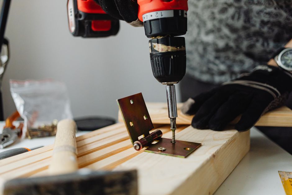 Skilled carpenter installing a custom wood cabinet