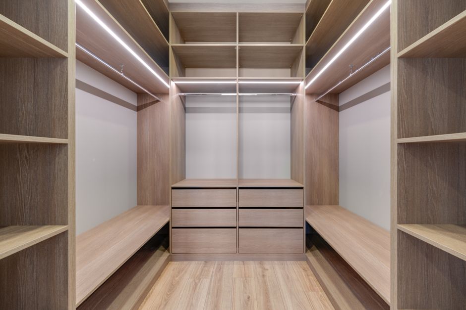 Beautifully organized wooden closet shelves in a walk-in